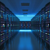 Modern web network and internet telecommunication technology, big data storage and cloud computing computer service business concept: server room interior in datacenter in blue light