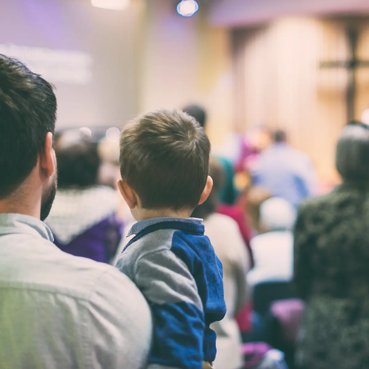 Man and son worship in a church that has IT security installed with the help of InfinIT specialists.