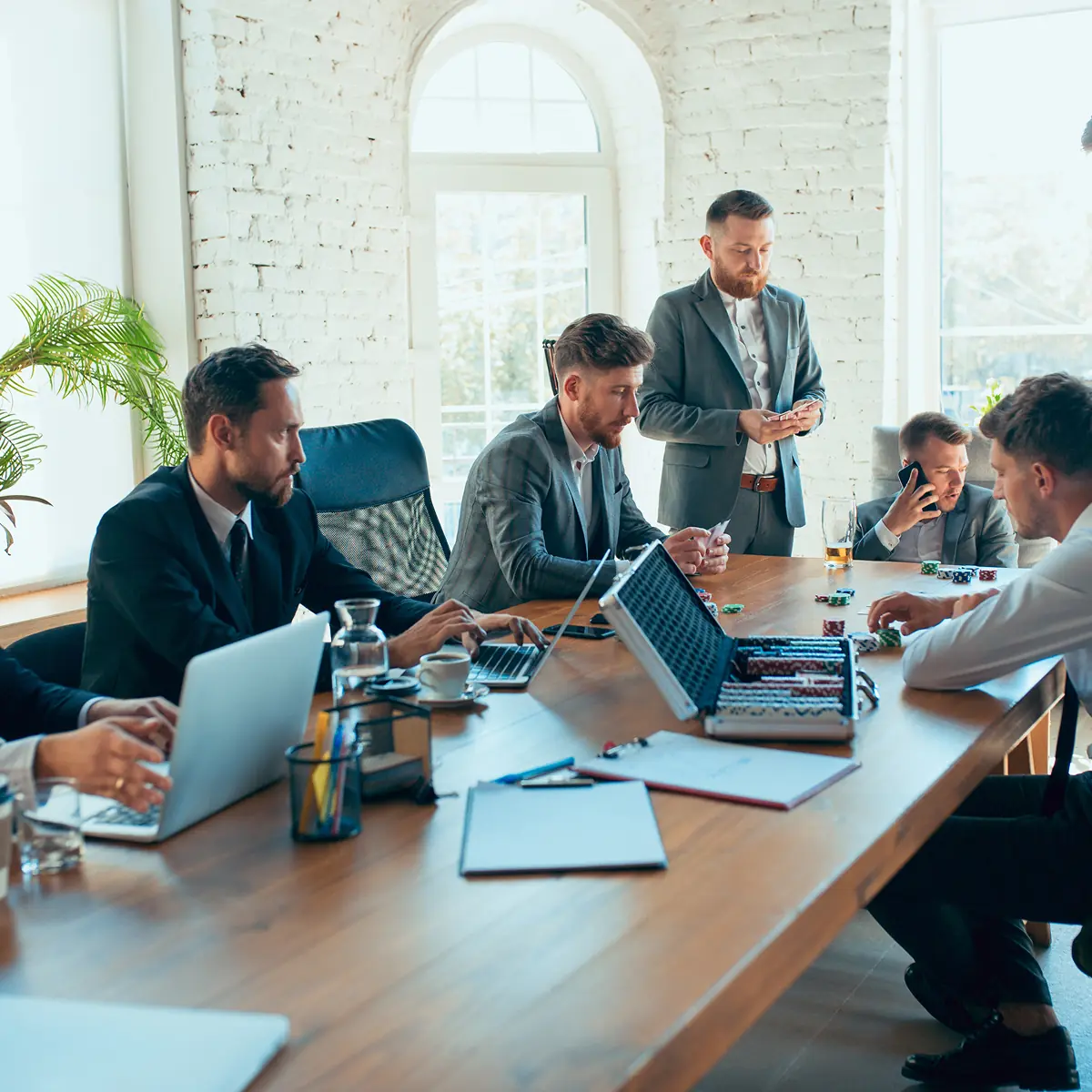 An InfinIT technology consultant in a meeting with engineers at a Northeast Ohio firm, while they pause to make plans on their devices.