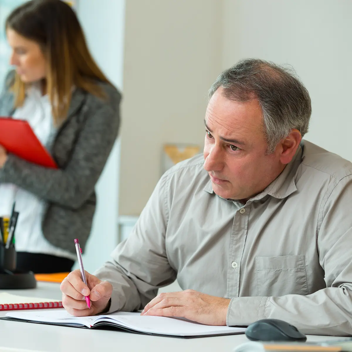 An InfinIT specialist explaining data protection strategies to administrators at a Northeast Ohio city hall, while he takes notes.