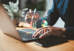 Business professional analyzing IT budget data charts and financial metrics for managed services plans.