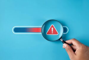 Magnifying glass examining IT support warning alert for unresponsive technical support.