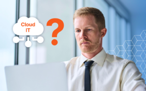A small business owner using laptop cloud technology in the office.