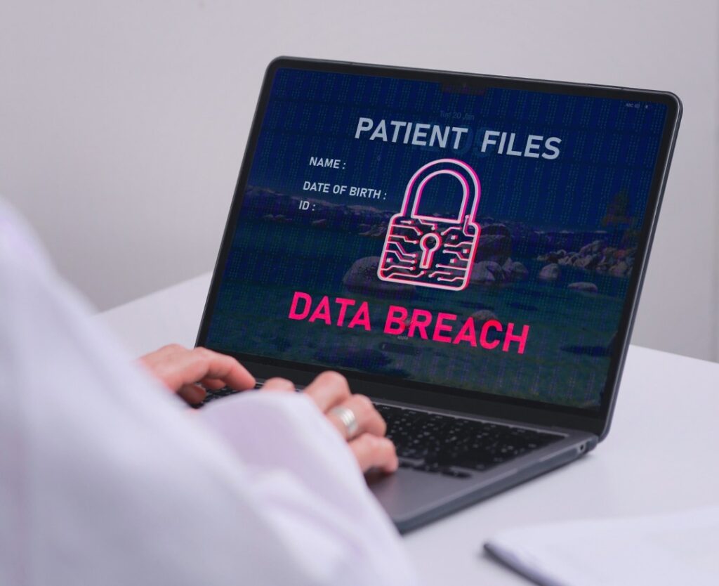 HIPAA compliance data breach warning on laptop showing patient files security risk for Northeast Ohio healthcare providers
