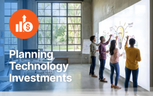 A business team reviewing a technology roadmap on a whiteboard.